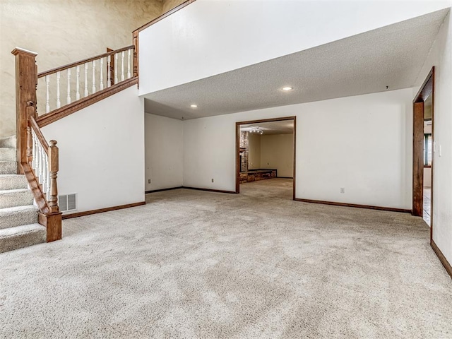 19005 Aerial Rd, Edmond, OK 73012 - unfurnished living room featuring carpet, stairs, baseboards, and recessed lighting