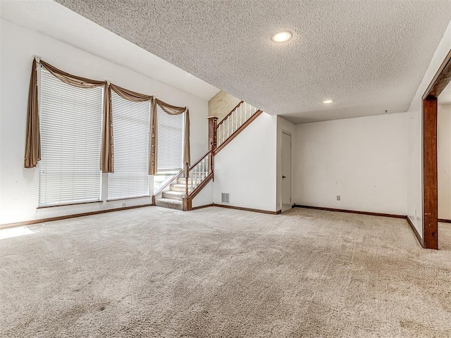 19005 Aerial Rd, Edmond, OK 73012 - carpeted empty room with a textured ceiling, stairs, baseboards, and recessed lighting