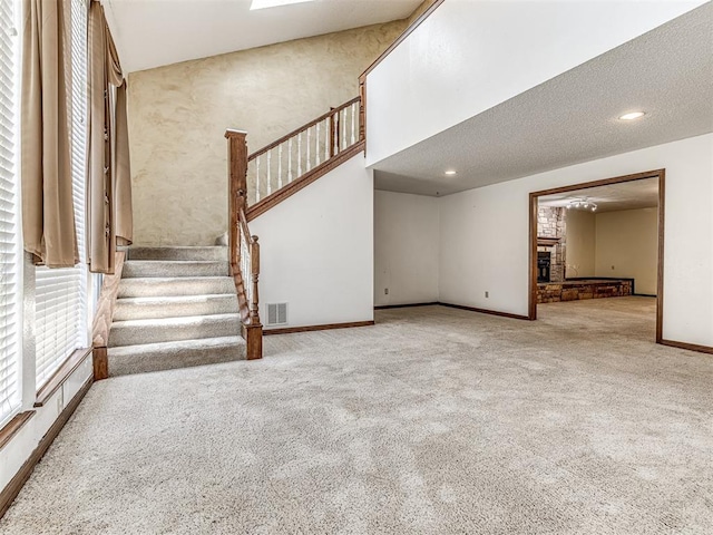 19005 Aerial Rd, Edmond, OK 73012 - unfurnished living room featuring carpet flooring, baseboards, and stairs