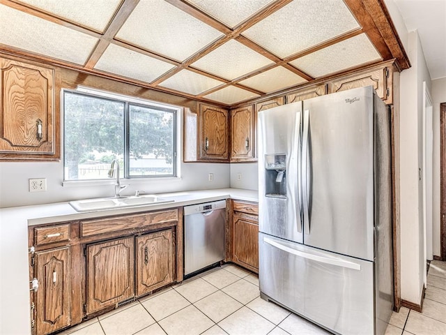 19005 Aerial Rd, Edmond, OK 73012 - kitchen with appliances with stainless steel finishes, a sink, brown cabinets, light countertops, and light tile patterned flooring