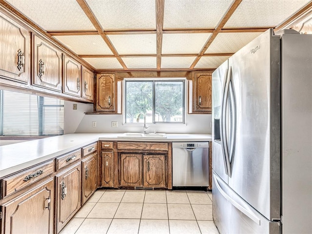 19005 Aerial Rd, Edmond, OK 73012 - kitchen with stainless steel appliances, a sink, light countertops, and brown cabinetry