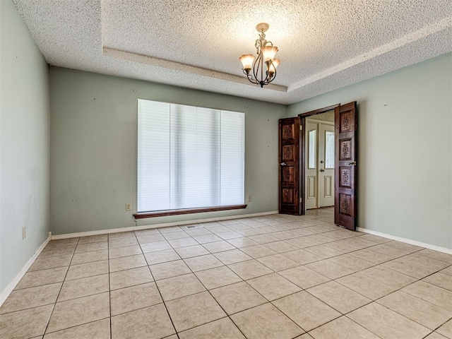 19005 Aerial Rd, Edmond, OK 73012 - unfurnished room with a textured ceiling, a chandelier, light tile patterned floors, and baseboards