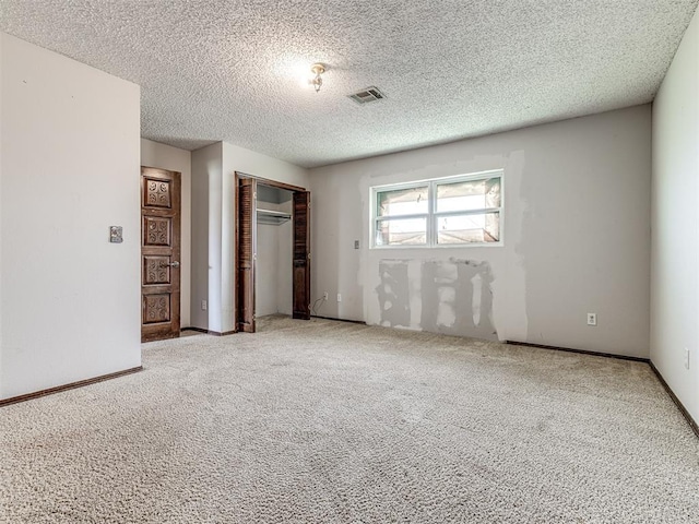 19005 Aerial Rd, Edmond, OK 73012 - unfurnished bedroom featuring carpet flooring, a closet, baseboards, and a textured ceiling