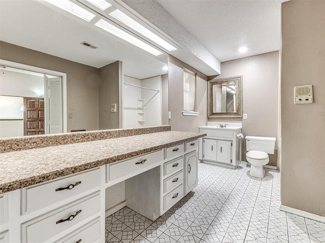 19005 Aerial Rd, Edmond, OK 73012 - full bathroom with vanity, baseboards, a textured wall, toilet, and a shower