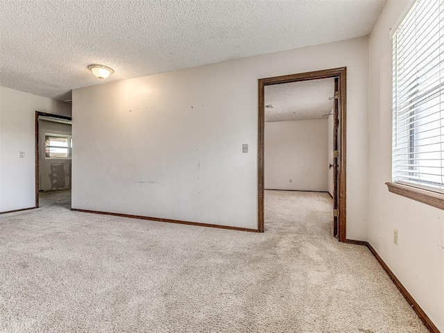 19005 Aerial Rd, Edmond, OK 73012 - empty room with a textured ceiling, light carpet, and baseboards