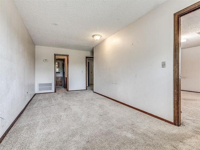 19005 Aerial Rd, Edmond, OK 73012 - unfurnished room featuring a textured ceiling, carpet floors, and baseboards