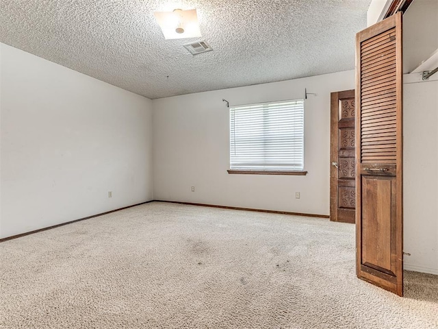 19005 Aerial Rd, Edmond, OK 73012 - unfurnished room featuring light colored carpet, a textured ceiling, and baseboards