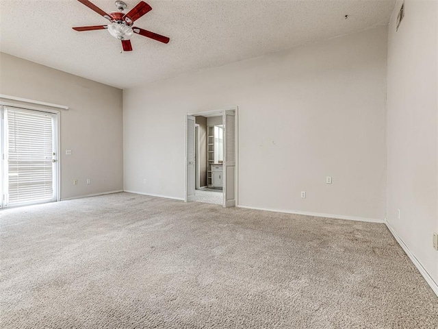 19005 Aerial Rd, Edmond, OK 73012 - spare room with carpet floors, a ceiling fan, a textured ceiling, and baseboards