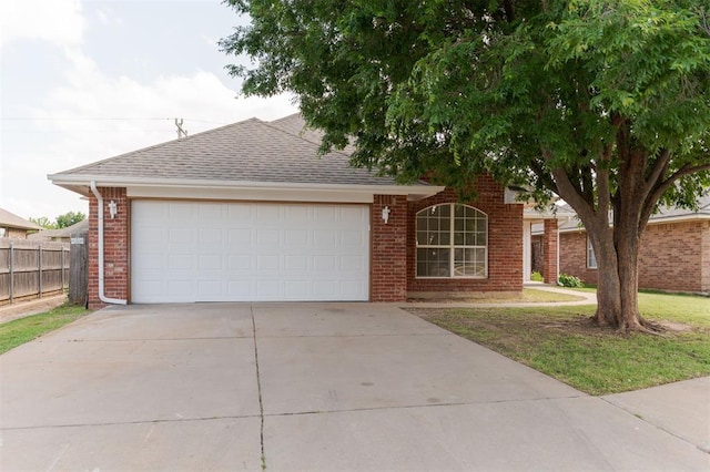 2016 NW 172nd St, Edmond, OK 73012 - view of front of house featuring brick siding, concrete driveway, a garage, and a shingled roof