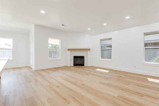 2016 NW 172nd St, Edmond, OK 73012 - unfurnished living room featuring a fireplace, recessed lighting, light wood-type flooring, and baseboards