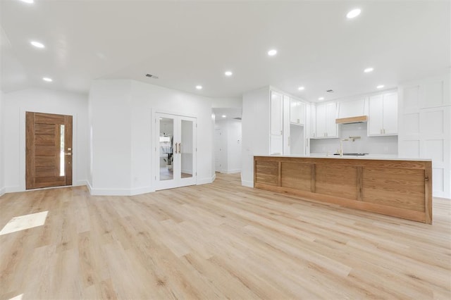 2016 NW 172nd St, Edmond, OK 73012 - kitchen with light wood-style flooring, french doors, light countertops, white cabinetry, and baseboards