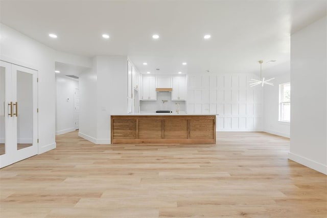 2016 NW 172nd St, Edmond, OK 73012 - kitchen with french doors, open floor plan, white cabinets, baseboards, and a peninsula