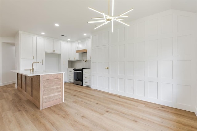 2016 NW 172nd St, Edmond, OK 73012 - kitchen featuring stainless steel range with electric cooktop, light wood-style floors, light countertops, a sink, and recessed lighting