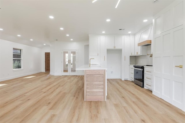 2016 NW 172nd St, Edmond, OK 73012 - kitchen with electric range, custom exhaust hood, recessed lighting, french doors, and white cabinets