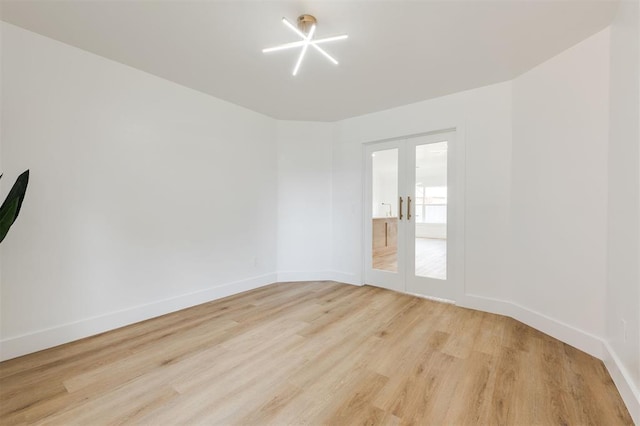 2016 NW 172nd St, Edmond, OK 73012 - empty room featuring french doors, light wood-style floors, and baseboards