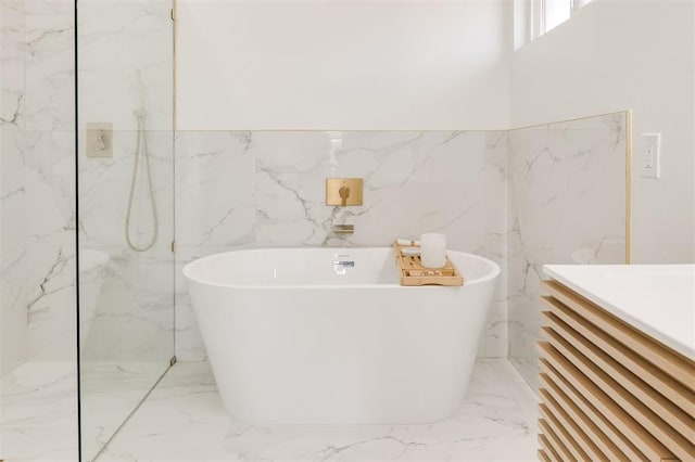 2016 NW 172nd St, Edmond, OK 73012 - full bath with marble tiled flooring, tile walls, a freestanding tub, vanity, and a marble finish shower