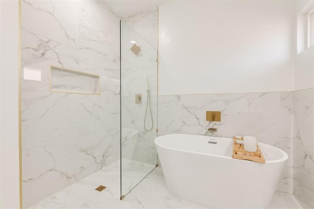 2016 NW 172nd St, Edmond, OK 73012 - bathroom with marble tiled flooring, a freestanding tub, a marble finish shower, and tile walls