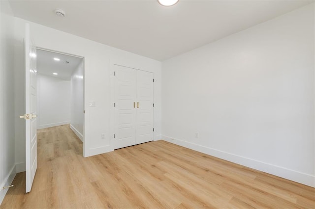 2016 NW 172nd St, Edmond, OK 73012 - unfurnished bedroom featuring light wood-style floors, baseboards, a closet, and recessed lighting