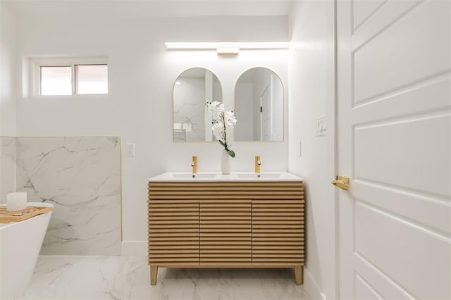 2016 NW 172nd St, Edmond, OK 73012 - full bathroom with marble finish floors, double vanity, a freestanding tub, and baseboards