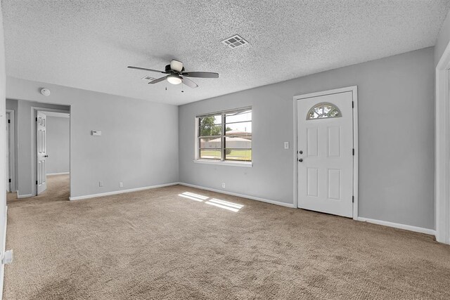 1036 Box St, Altus, OK 73521 - foyer featuring ceiling fan, carpet flooring, a textured ceiling, and baseboards