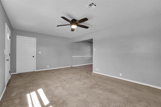 1036 Box St, Altus, OK 73521 - carpeted empty room with a ceiling fan, a textured ceiling, and baseboards