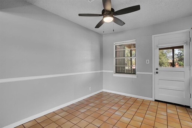 1036 Box St, Altus, OK 73521 - foyer featuring a textured ceiling, a ceiling fan, and baseboards
