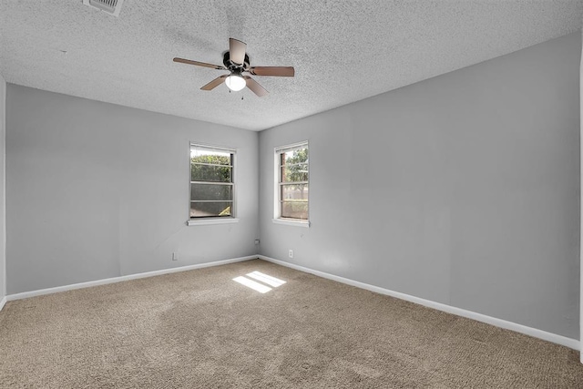1036 Box St, Altus, OK 73521 - empty room featuring ceiling fan, carpet, a textured ceiling, and baseboards