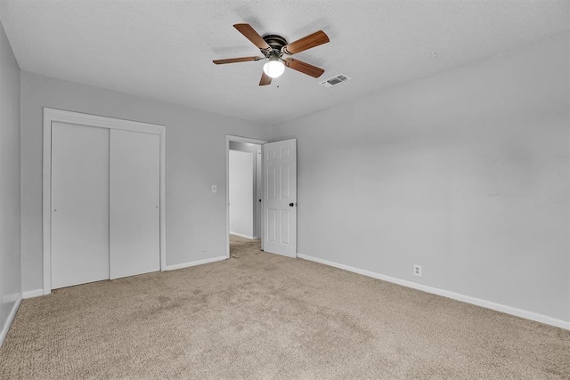 1036 Box St, Altus, OK 73521 - unfurnished bedroom featuring carpet floors, baseboards, a closet, and a ceiling fan