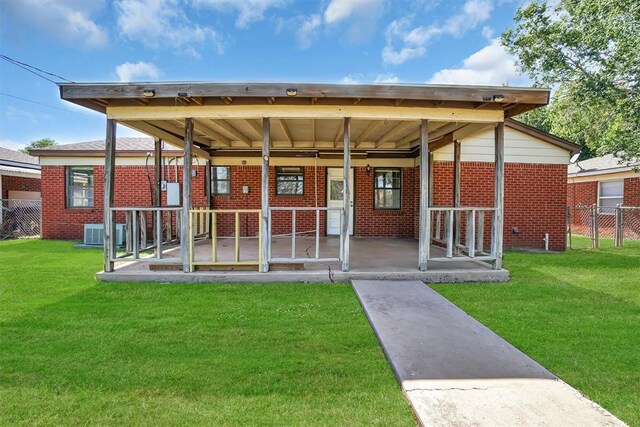1036 Box St, Altus, OK 73521 - view of front of property with brick siding, a patio, and central air condition unit