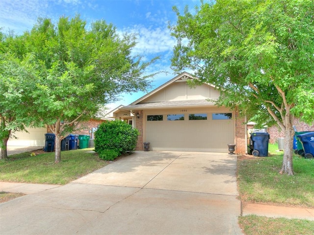19901 Adagio Ln, Edmond, OK 73012 - view of front facade featuring an attached garage, driveway, and brick siding