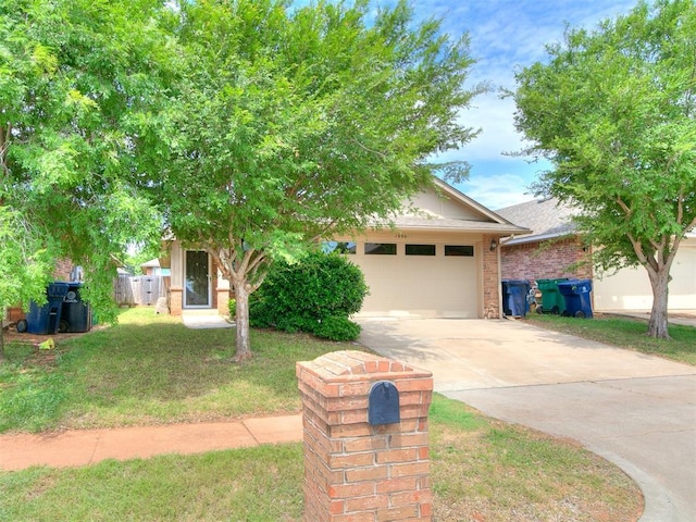 19901 Adagio Ln, Edmond, OK 73012 - view of property hidden behind natural elements featuring driveway, a garage, a front lawn, and brick siding