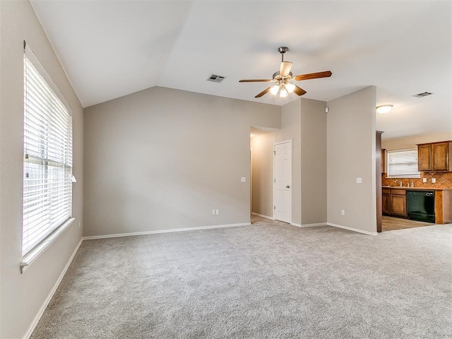 19901 Adagio Ln, Edmond, OK 73012 - unfurnished living room with ceiling fan, light carpet, vaulted ceiling, a sink, and baseboards