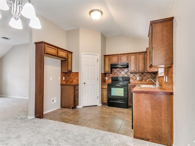 19901 Adagio Ln, Edmond, OK 73012 - kitchen featuring black range with electric cooktop, lofted ceiling, a sink, brown cabinetry, and light colored carpet