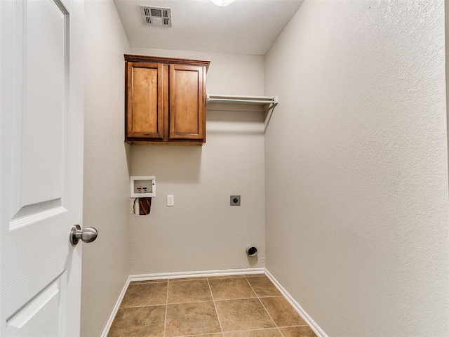 19901 Adagio Ln, Edmond, OK 73012 - laundry area with baseboards, electric dryer hookup, cabinet space, washer hookup, and tile patterned floors