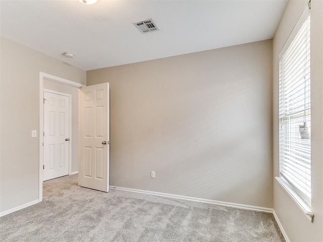 19901 Adagio Ln, Edmond, OK 73012 - unfurnished room with light carpet, baseboards, and plenty of natural light