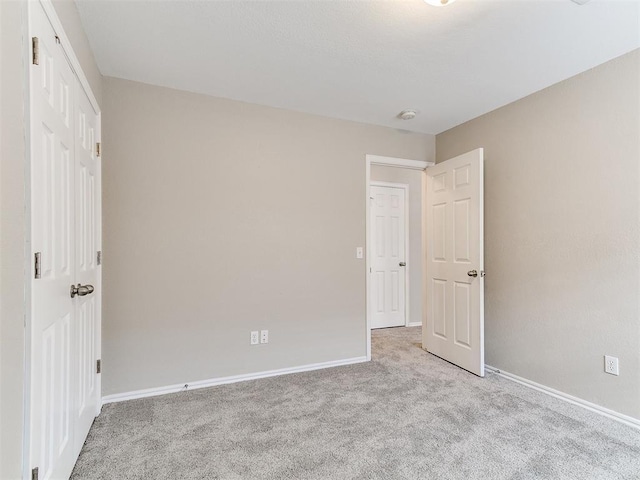 19901 Adagio Ln, Edmond, OK 73012 - unfurnished bedroom with carpet floors, baseboards, and a closet