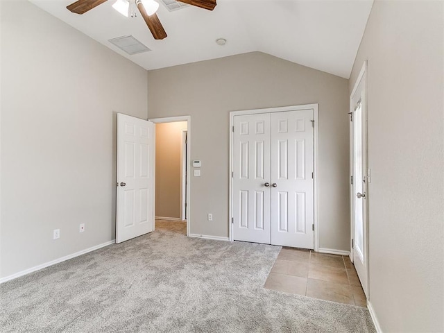 19901 Adagio Ln, Edmond, OK 73012 - unfurnished bedroom with vaulted ceiling, carpet flooring, a closet, ceiling fan, and tile patterned flooring