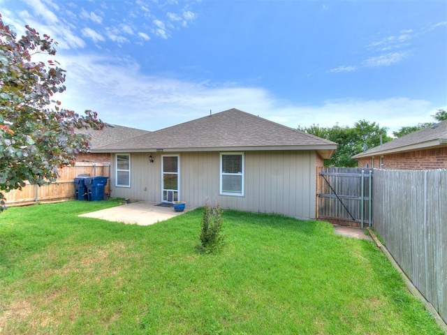 19901 Adagio Ln, Edmond, OK 73012 - rear view of house with a patio area, roof with shingles, and a gate