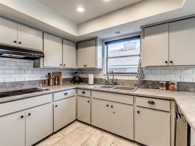 13613 Pin Oak, Edmond, OK 73013 - kitchen featuring a sink, under cabinet range hood, light tile patterned floors, backsplash, and black electric cooktop