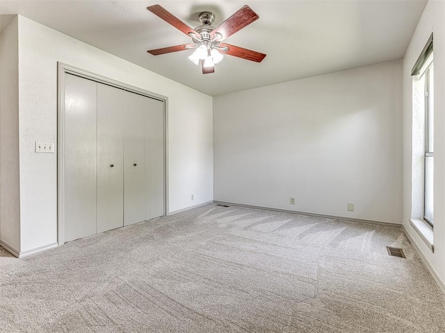 13613 Pin Oak, Edmond, OK 73013 - unfurnished bedroom with carpet, a closet, a ceiling fan, and baseboards