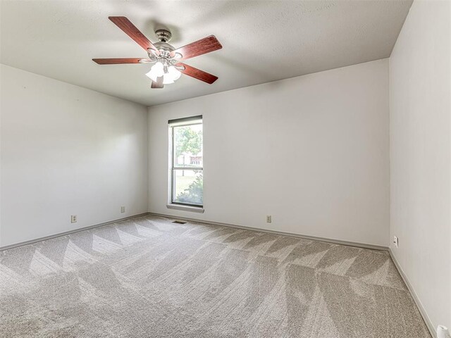13613 Pin Oak, Edmond, OK 73013 - unfurnished room featuring light colored carpet, a ceiling fan, and baseboards