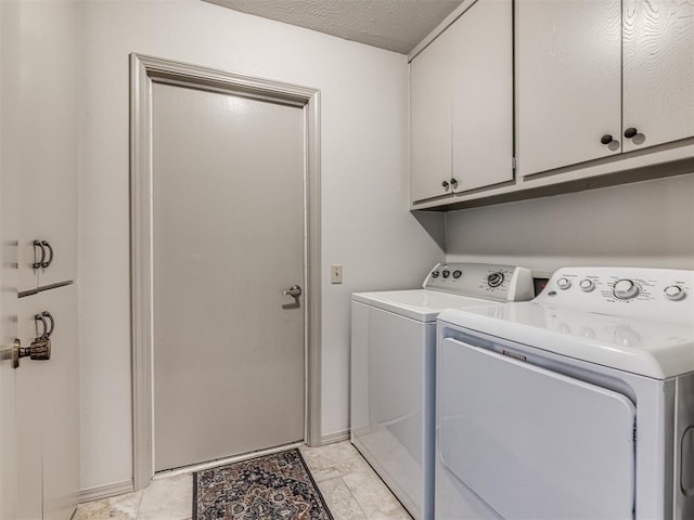 13613 Pin Oak, Edmond, OK 73013 - laundry room with washer and dryer, cabinet space, a textured ceiling, and baseboards