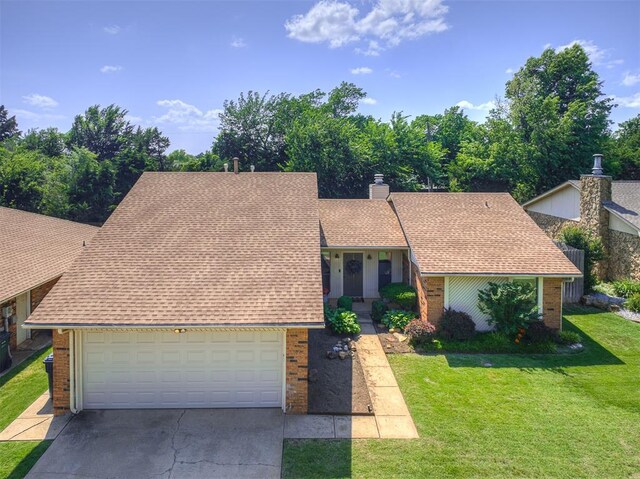 13613 Pin Oak, Edmond, OK 73013 - a-frame home with brick siding, a shingled roof, driveway, and a front yard