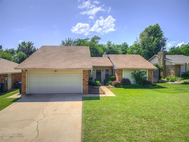 13613 Pin Oak, Edmond, OK 73013 - view of front facade with brick siding, driveway, a front lawn, and an attached garage