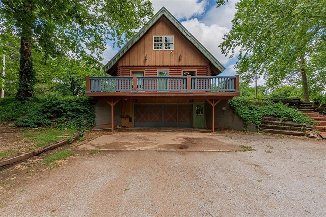 1000 N Canadian Ave, Purcell, OK 73080 - log cabin with log siding, a wooden deck, and an attached garage