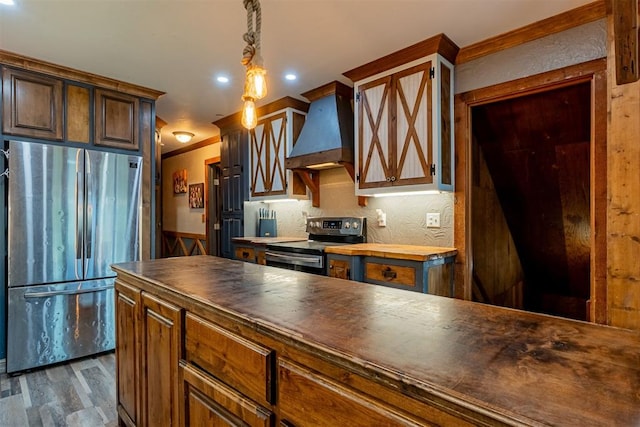 1000 N Canadian Ave, Purcell, OK 73080 - kitchen with stainless steel appliances, custom range hood, butcher block countertops, dark wood-style flooring, and recessed lighting