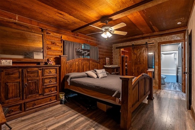 1000 N Canadian Ave, Purcell, OK 73080 - bedroom with wooden ceiling with exposed beams, dark wood-style flooring, a barn door, and rustic walls