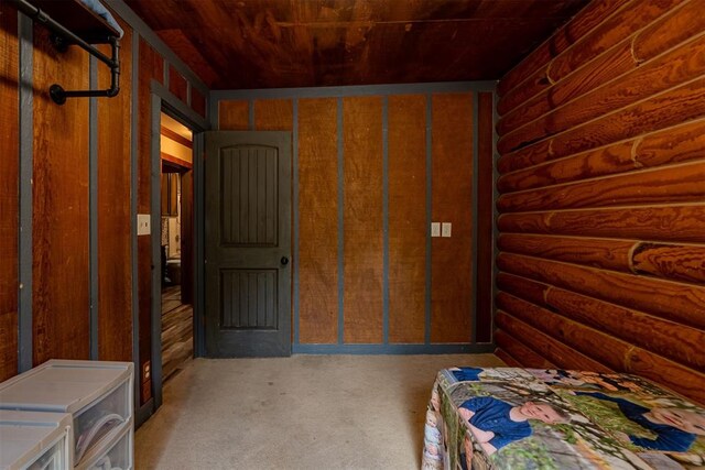 1000 N Canadian Ave, Purcell, OK 73080 - carpeted bedroom with rustic walls and wood ceiling
