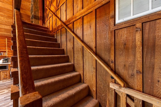 1000 N Canadian Ave, Purcell, OK 73080 - stairs with wood walls and wood finished floors