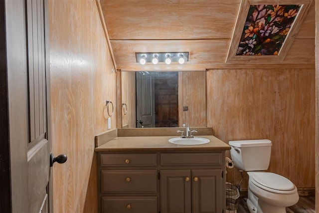 1000 N Canadian Ave, Purcell, OK 73080 - bathroom with vanity, toilet, and wood walls